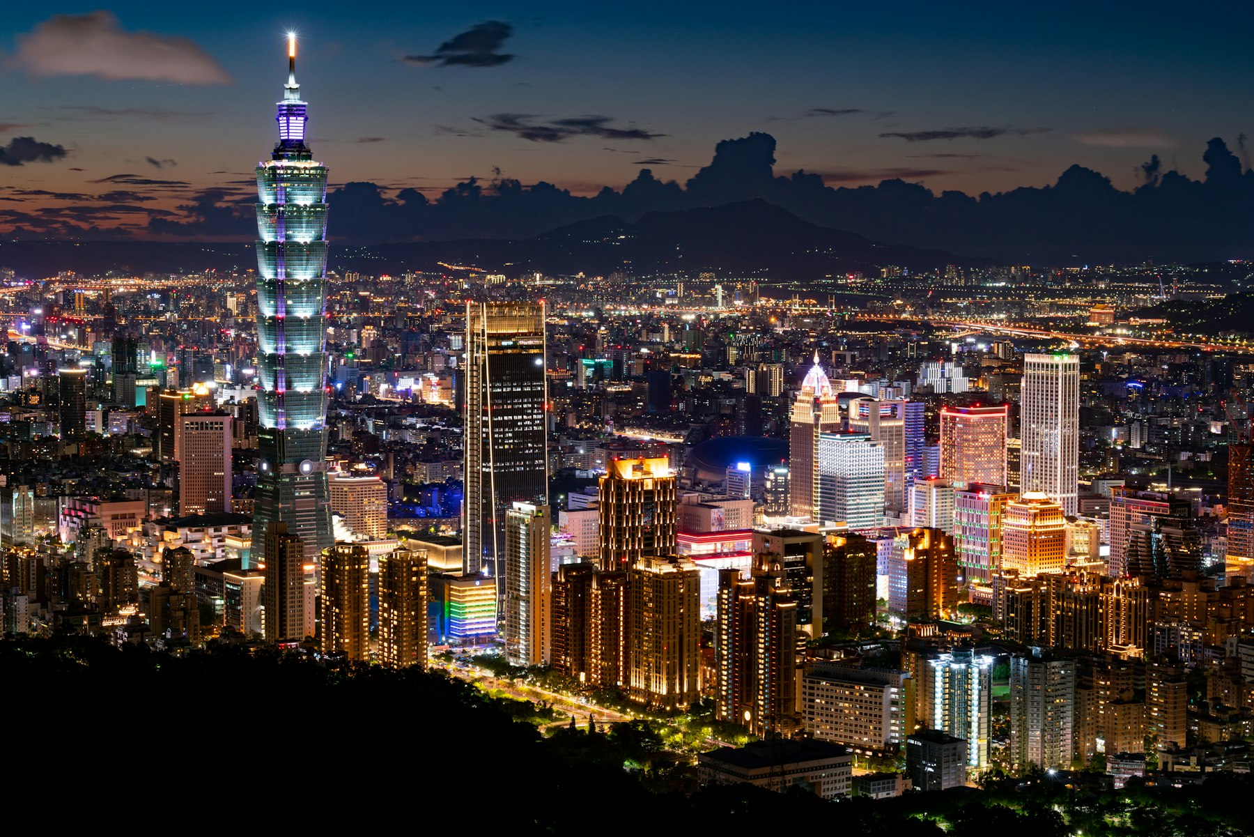 Night skyline of Taipei with Taipei 101 lit against the hills